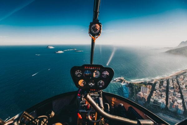 Helicopter interior as it flies along a coastal city